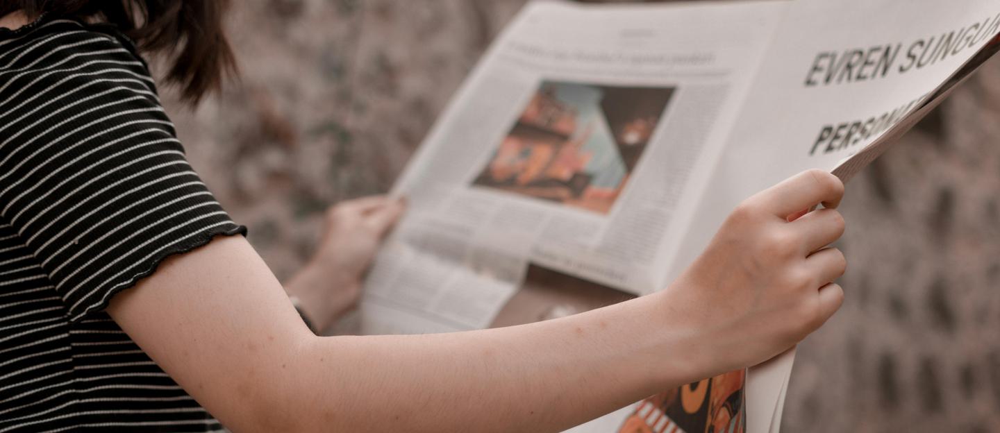 Stock image of woman reading a newspaper